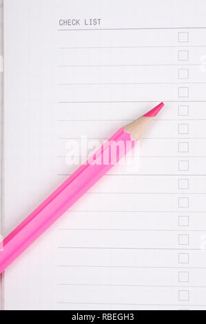 red or pink pencil on white note Stock Photo