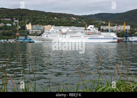 Evening view of white Japanese cruise liner Pacific Venus anchored at marine station in Sea Port of Petropavlovsk-Kamchatsky City Stock Photo