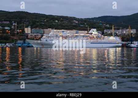 Picturesque night view of white Japanese cruise liner Pacific Venus anchored at pier in Petropavlovsk-Kamchatsky Seaport Stock Photo