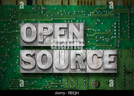 open source phrase made from metallic letterpress blocks on the pc board background Stock Photo