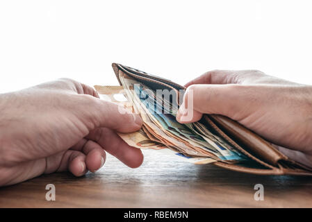 hands taking paper money out of wallet Stock Photo