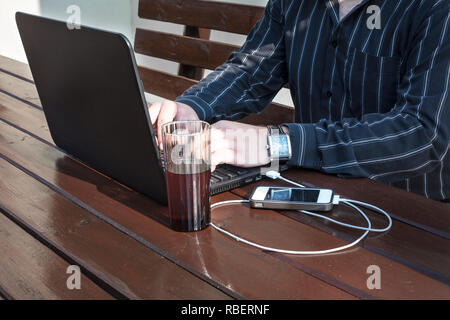 Programmer working on a code outdoors Stock Photo