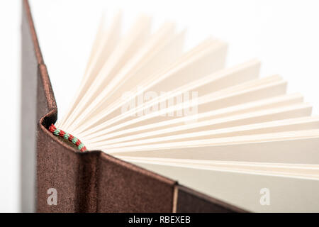Open empty white book. Closeup of several pages from a book, view from the corner. Stock Photo
