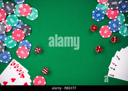 Casino games related items on green table, copy space. Stock Photo