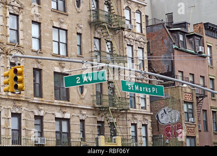 Street signs for hobo & hip St Marks Place and Second Avenue amid historic tenements and fire escapes in Manhattan's East Village, New York City. Stock Photo