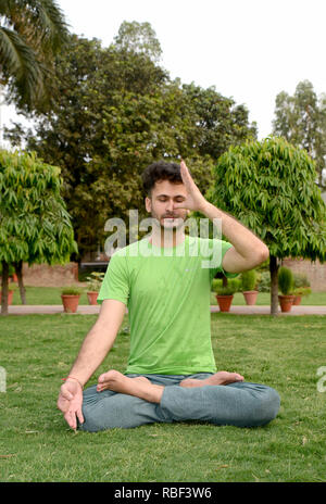 Young man meditating Stock Photo