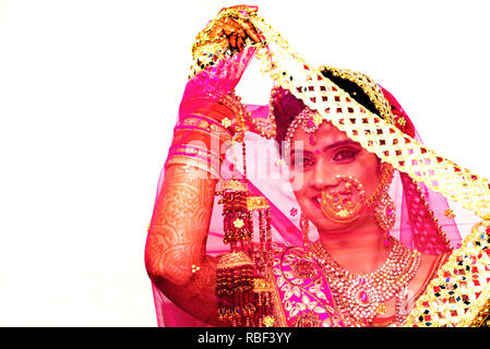 Cheerful Indian bride  in glamorous outfit and jewelry Stock Photo