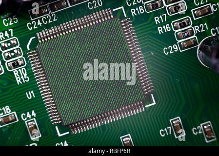 Electronic Computer processor in a computer circuit board. Two photographers binary coding one zero and computer motherboard merged together. Stock Photo
