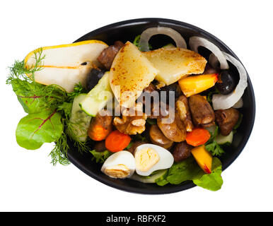 Appetizing braised chicken hearts served in salad with roasted cheese, fresh peach, pear, walnuts and quail eggs. Isolated over white background Stock Photo