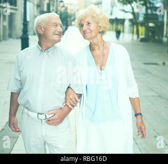 Portrait of loving mature spouses enjoying walk around European city Stock Photo