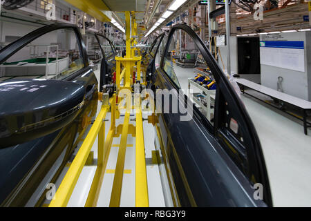 car door on conveyor. Robotic equipment makes Assembly of car. Modern car Assembly at factory Stock Photo