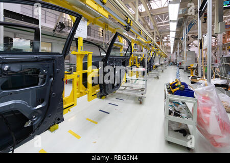 car door on conveyor. Robotic equipment makes Assembly of car. Modern car Assembly at factory Stock Photo