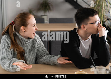 Young woman yelling at boyfriend in hysterics, drama queen screaming loud shouting at husband trying to get attention, having a tantrum, lack of emotional intelligence, manipulation in relationships Stock Photo