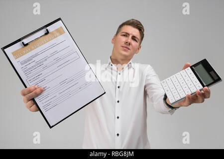 Portrait of young man with form of payment of bills and calculator in his hands isolated on white background Stock Photo