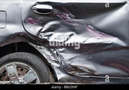 Car accident. Damaged car door, wing and broken wing mirror following a ...