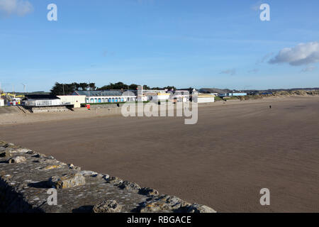 Sand Bay at Porthcawl on a sunny winters day with everyone out for a walk along the promenade beside the seaside in this popular seaside town. Stock Photo