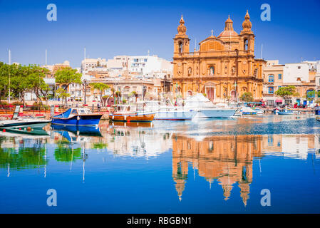 Valletta, Malta. Msida Marina boat and church reflection into water. Stock Photo