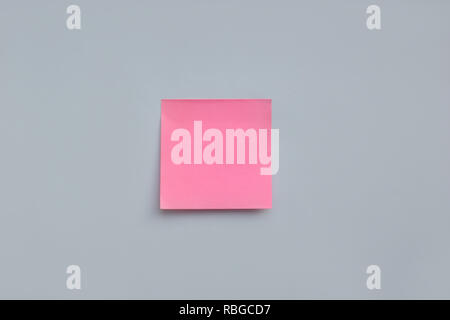 Pink sticky note with copy space on blue background Stock Photo