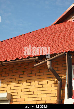 Rain gutter ice dams. Broken Rain Gutters and Downspout Drainepipe. Stock Photo