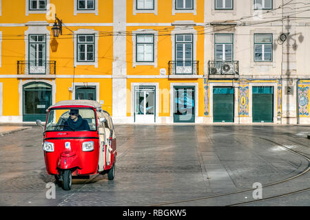 A three-wheel tuk tuk tourist taxi parked in a square of Baixa district, Lisbon, Portugal Stock Photo