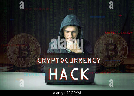 A hacker with a face is trying to steal cryptocurrency using a computer. Fraud and scam at Cryptojacking Stock Photo