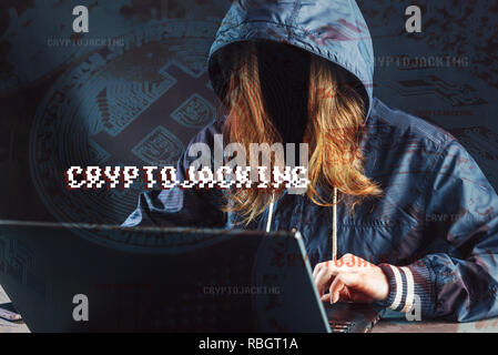 A girl hacker without a face is trying to steal cryptocurrency using a computer. Fraud and scam at Cryptojacking Stock Photo