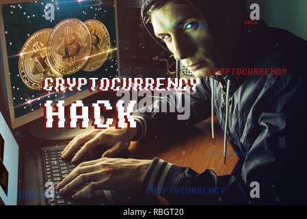 A hacker with a face is trying to steal cryptocurrency using a computer. Fraud and deception at Cryptojacking Stock Photo