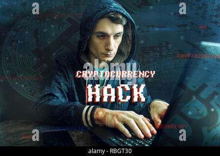 A hacker with a face is trying to steal cryptocurrency using a computer. Fraud and deception at Cryptojacking Stock Photo