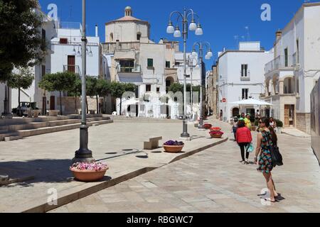 POLIGNANO A MARE, ITALY - MAY 29, 2017: People visit Polignano a Mare Old Town in Apulia, Italy. With 50.7 million annual visitors Italy is one of the Stock Photo