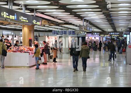 MADRID, SPAIN - DECEMBER 6, 2016: Passengers visit Madrid Barajas Airport in Spain. It is the 6th busiest airport in Europe, with 50.4 million passeng Stock Photo