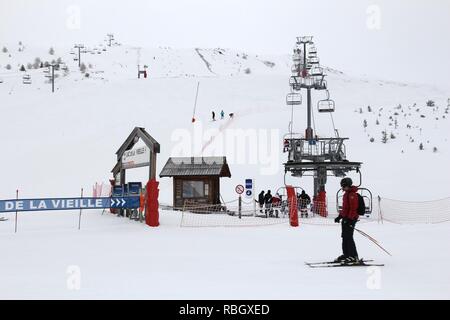 VALLOIRE, FRANCE - MARCH 27, 2015: Skiers go up the lift in Galibier-Thabor station in France. The station is located in Valmeinier and Valloire and h Stock Photo