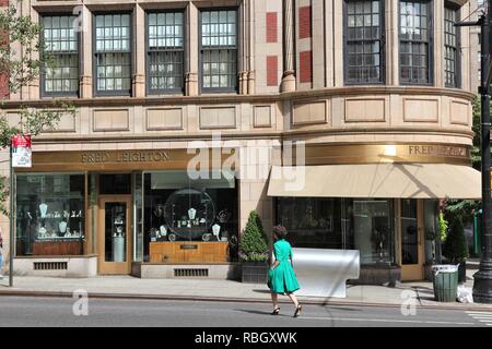 NEW YORK, USA - JULY 2, 2013: Person walks in front of Fred Leighton jewelry store in Madison Avenue, NY. Madison Avenue is one of the most recognized Stock Photo