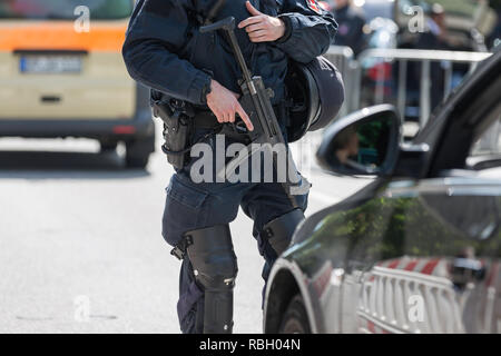 german policeman with machine gun doing security control Stock Photo