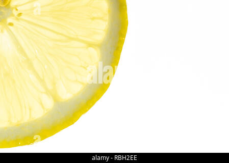 Lemon slice close-up backlit on white background Stock Photo