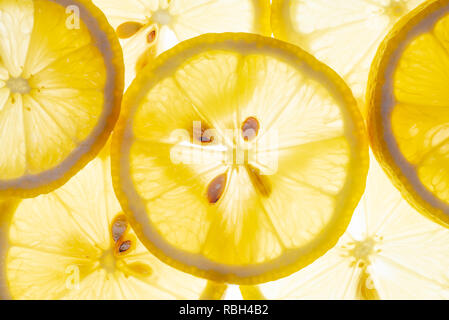 Fresh lemon slices heap backlit close-up view Stock Photo