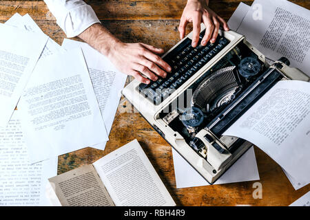 Young man's hands typing on an antique vintage typewriter Stock Photo