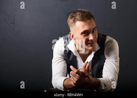Portrait of young handsome man wearing white shirt standing on the gray background and smiling Stock Photo