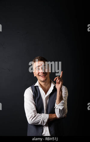 Portrait of young handsome man wearing white shirt standing on the gray background, smiling and raised thumbs up Stock Photo