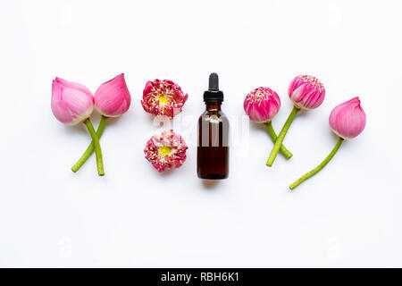 Lotus essential oil with lotus flowers on white background. Stock Photo