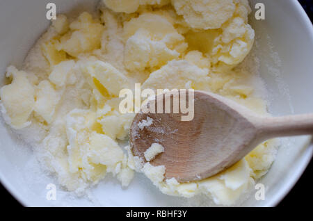 Mixing butter and sugar in bowl Stock Photo