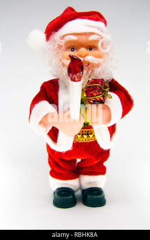 Santa Claus Doll Isolated With White Background. Adorable Santa Claus Decorative Toy, Insulator on a White Background. Christmas and New Year Symbols. Stock Photo