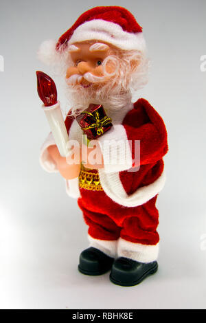 Santa Claus Doll Isolated With White Background. Adorable Santa Claus Decorative Toy, Insulator on a White Background. Christmas and New Year Symbols. Stock Photo