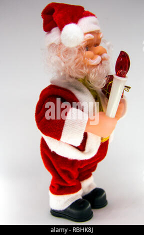 Santa Claus Doll Isolated With White Background. Adorable Santa Claus Decorative Toy, Insulator on a White Background. Christmas and New Year Symbols. Stock Photo