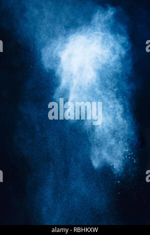 Flour powder explosion in motion. Action food photography. Light blue dust on a black background with copy space Stock Photo