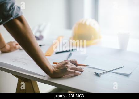 Construction engineering. Close up of engineers hands working on table Stock Photo