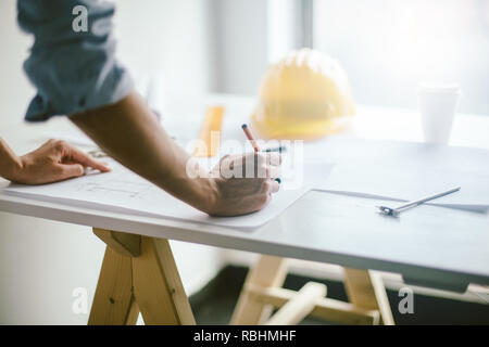 Construction engineering. Close up of architect hands working on table Stock Photo