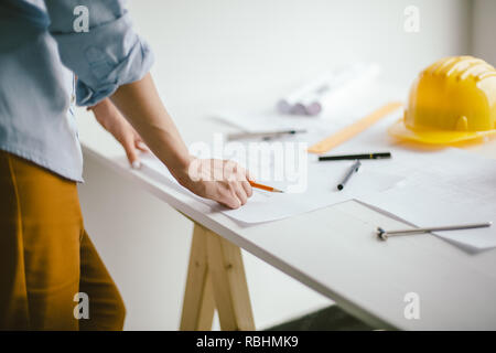 Construction engineering. Close up of architect hands working on table Stock Photo