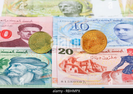 Tunisian Dinar coins on the background of banknotes Stock Photo