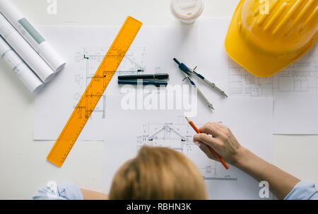 High angle view of architect drawing blueprints. Architectural/engineering project concept Stock Photo