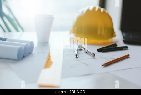 Engineers equipment and blueprints on the office desk. Construction engineer equipment Stock Photo